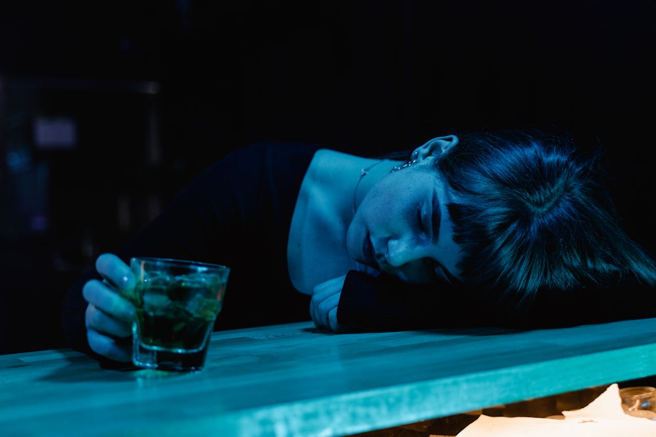 Woman passed out on a bar after mixing codeine and alcohol.
