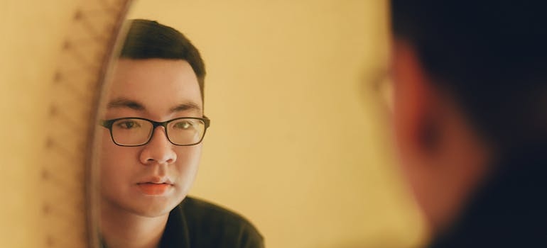 Man looking at himself in the mirror.