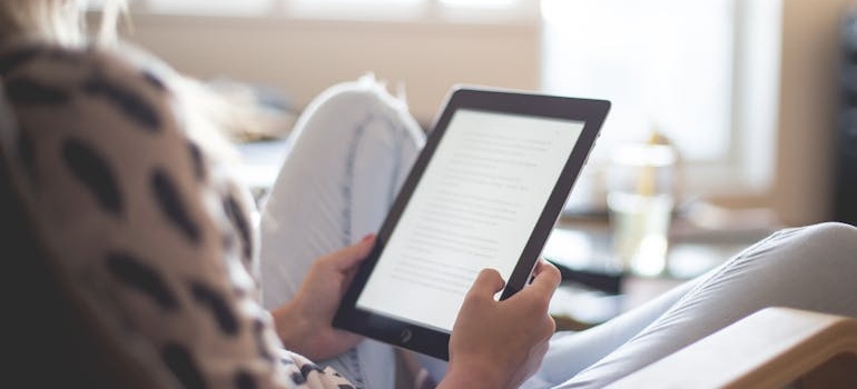 Person reading a memoir on kindle.
