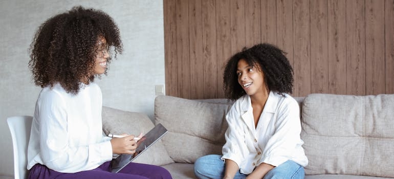 Woman talking about tailored detox programs with her therapist.