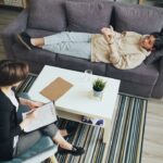 Therapist explaining how to talk about trauma in therapy with her patient.