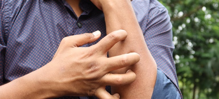 Man itching his arm.