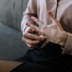 Woman taking off her wedding ring.