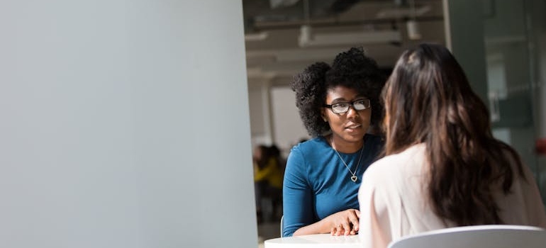 Two women having a serious conversation.
