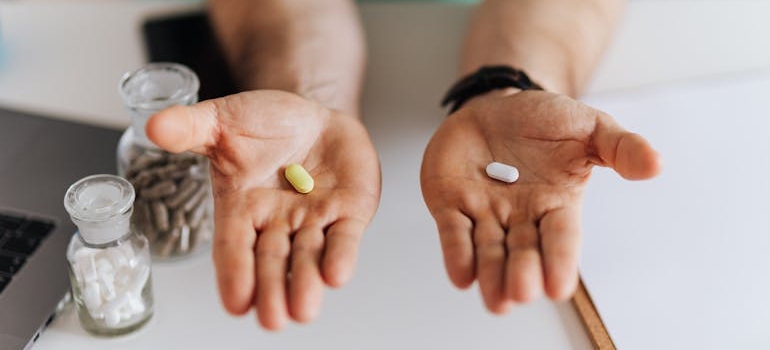 Doctor holding two types of pills.