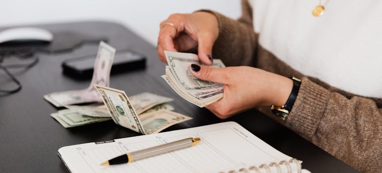 Woman counting money while budgeting.