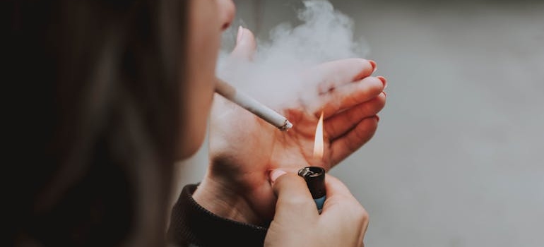 Woman lighting a cigarette.