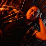 Man sleeping on the bed after ingesting Klonopin and alcohol.