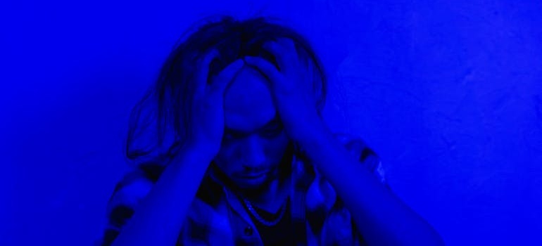 Man holding his head.