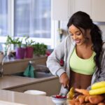 Woman making a healthy meal while worrying about both nutrition and mental health.