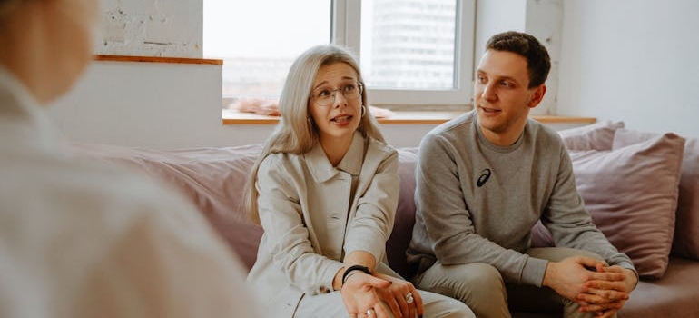 Couple talking about divorce and addiction with their therapist.
