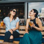 Women sitting at a pub and drinking beer.