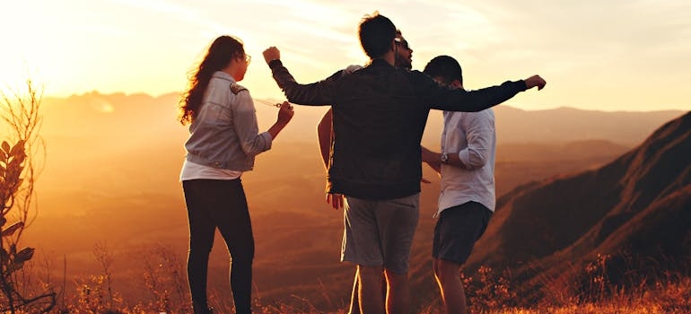 People hanging out and having fun on a cliff.