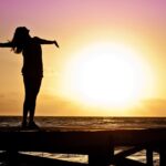 Woman looking at the sun while learning how to rebuild your life after rehab.
