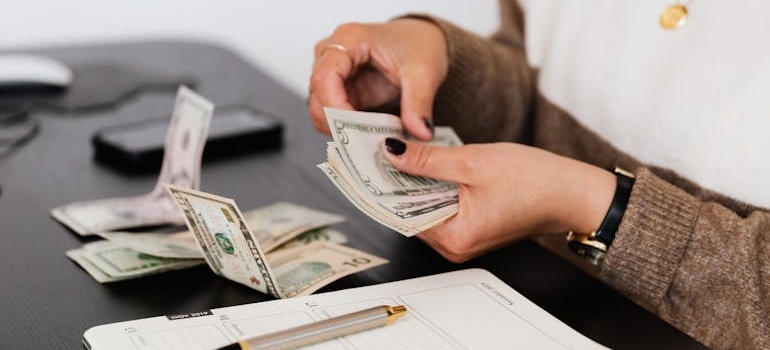 Woman budgeting money for bills.