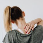 Woman touching her sore back.