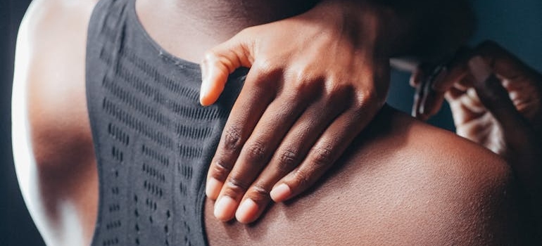 Woman touching her sore back.