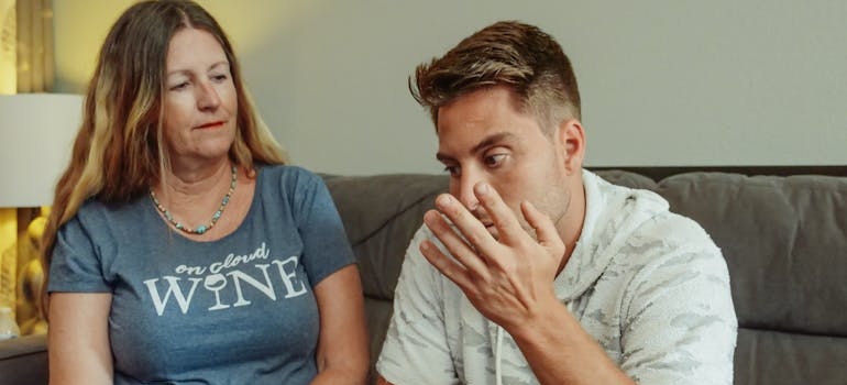 Addicted son talking with his mother.