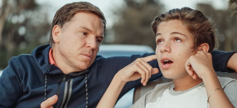 Father talking with his teenage son during a serious family conversation.