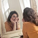 Woman looking at herself in the mirror.