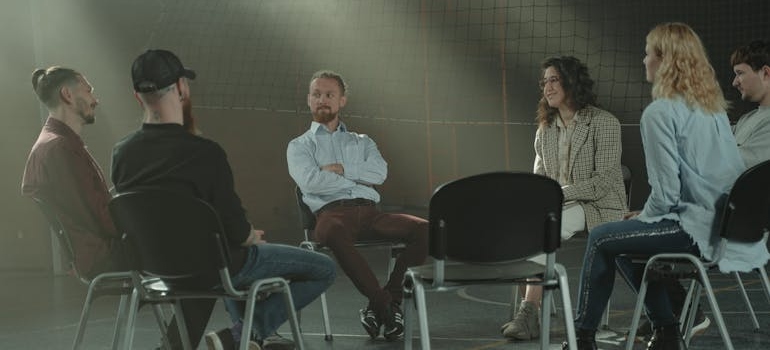 People in a support group meeting discussing how to rebuild your life.