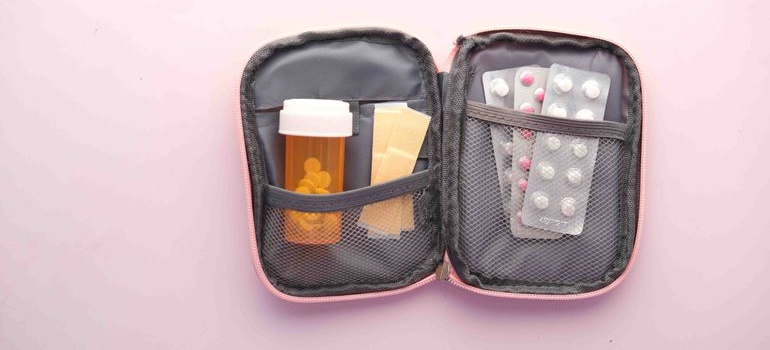 Open first aid kit with medication and emergency supplies for overdose preparedness.