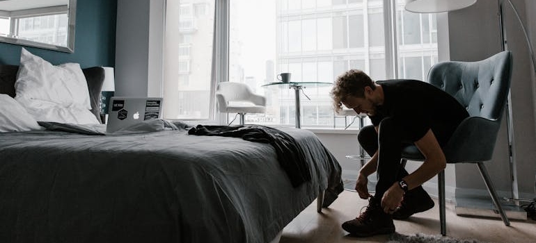 Man tying his shoes before starting his day.