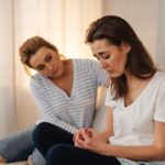 Two women discussing how to get a family member into drug rehab.