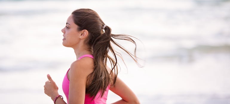 Woman running along the beachside.