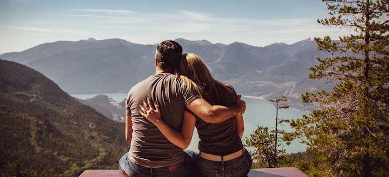 Couple hugging each other while looking at the nature view.