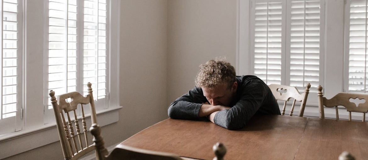Worried man thinking about can an alcoholic ever drink again.