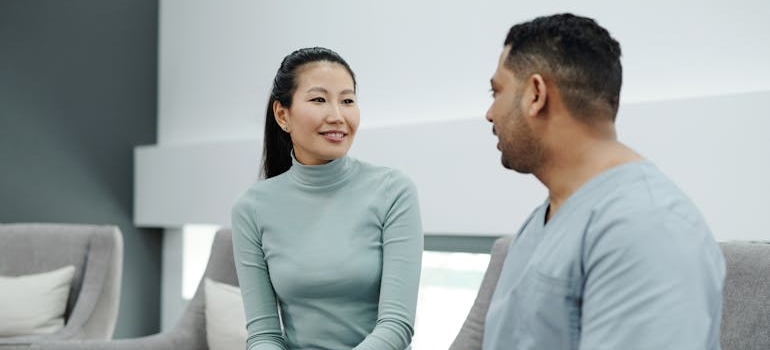 Woman talking to a nurse in a treatment program.