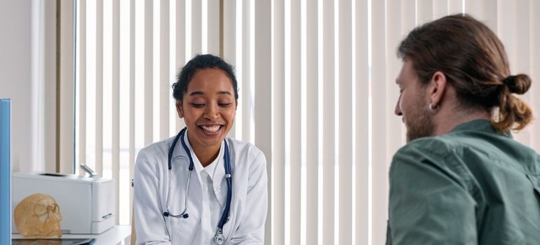 Male patient speaking with a doctor about his precipitated withdrawal symptoms.