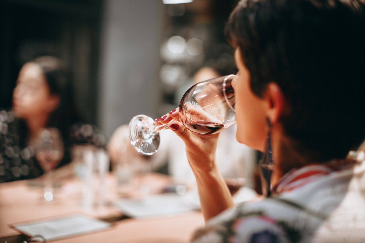 Woman drinking a glass of wine.