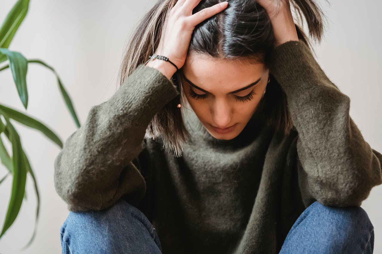 Woman having a headache and holding her head.