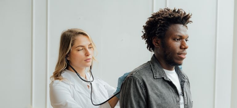 Male patient being assessed by a healthcare professional before treatment for precipitated withdrawal.