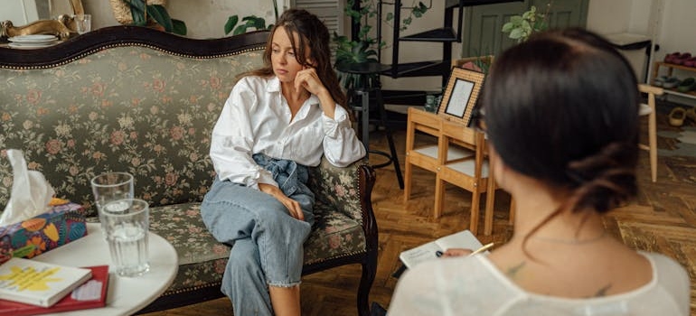 Woman sitting in a therapy session with a therapist.