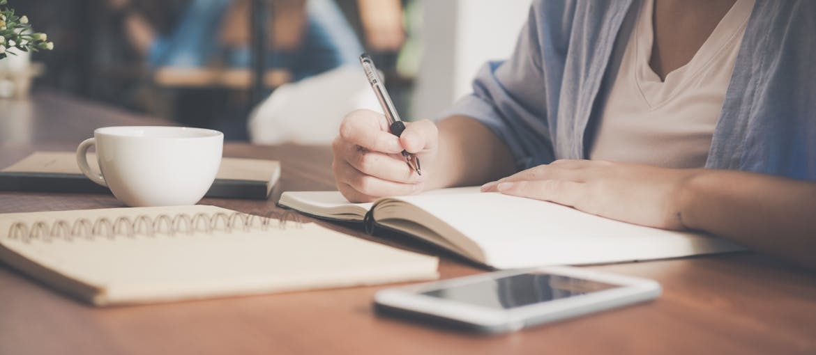 Woman journaling about can an alcohol ever drink again.