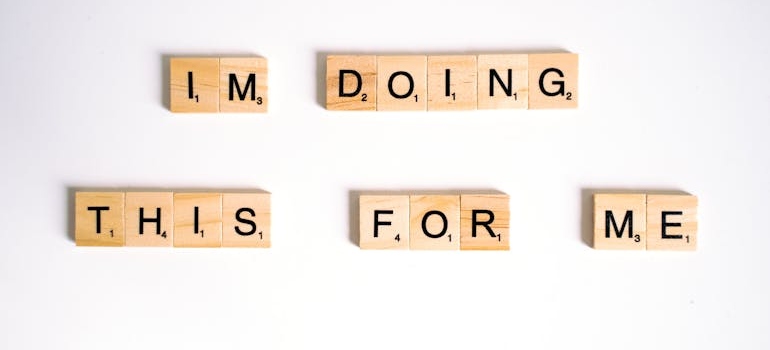 Positive affirmations for recovering addicts written with scrabble tiles.