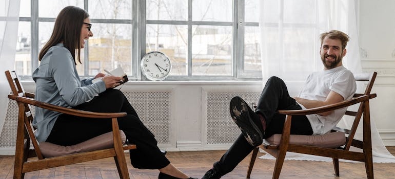 Man laughing while talking with his therapist.