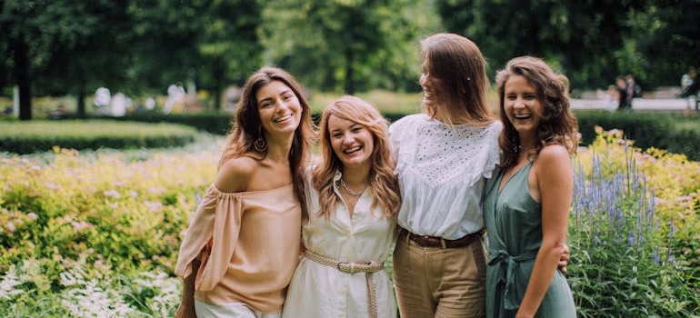 Four women hugging each other.