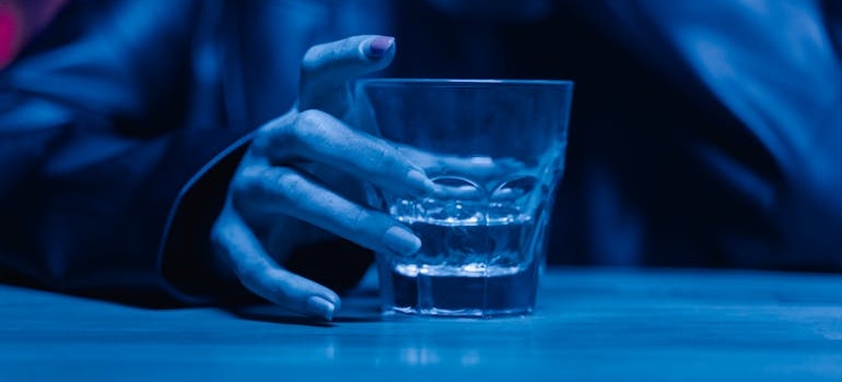 Woman holding a glass of alcohol.