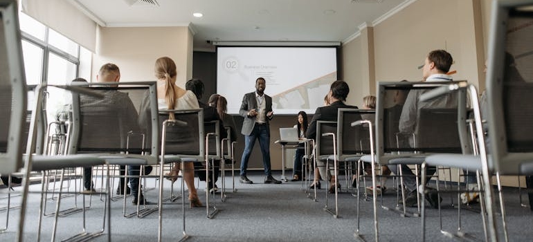 Man having a lecture about employment after rehab in front of a group of people.