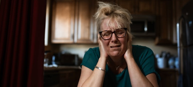 Sad woman covering his face while struggling with LSD and bipolar disorder.