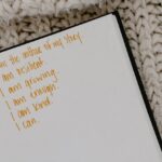 Positive affirmations for recovering addicts written in a notebook.