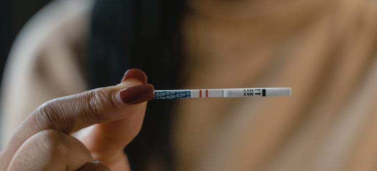 Woman holding positive fentanyl test strips.