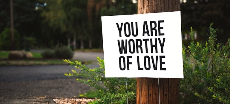 Positive affirmations for recovering addicts written on a road sign.