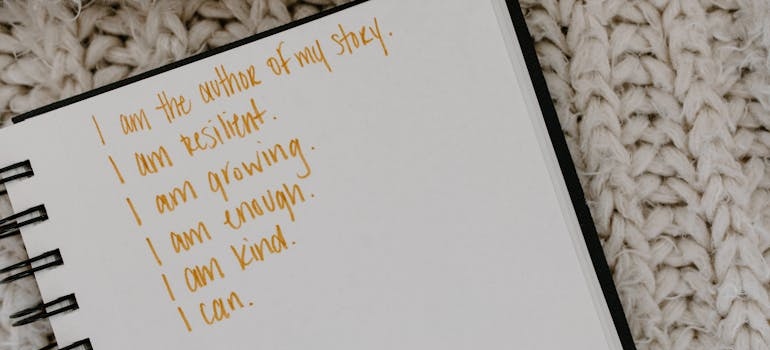 Positive affirmations written in a notebook.