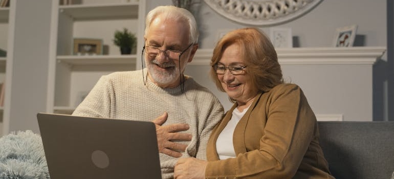 Grandparents looking at a laptop and planning how to protect a grandchild from a drug addicted parent.