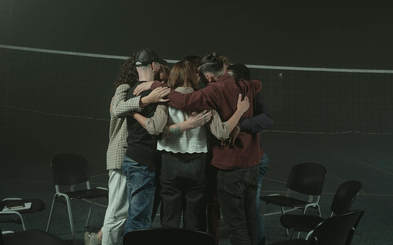 People in mental health support groups hugging each other.